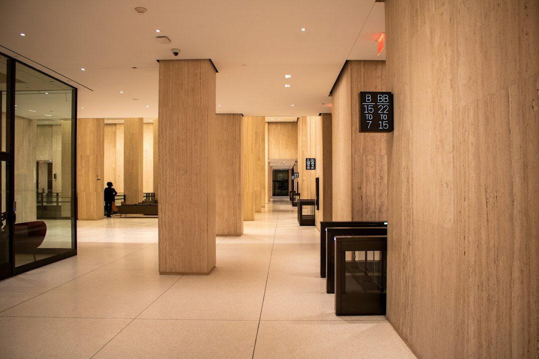 Bright reception area of a corporate office with seating and plants